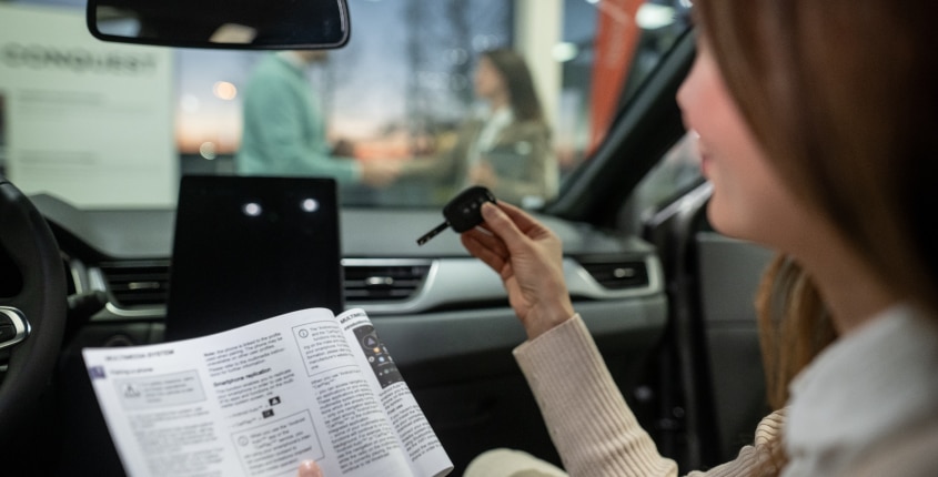 Woman with key and maintenance guide