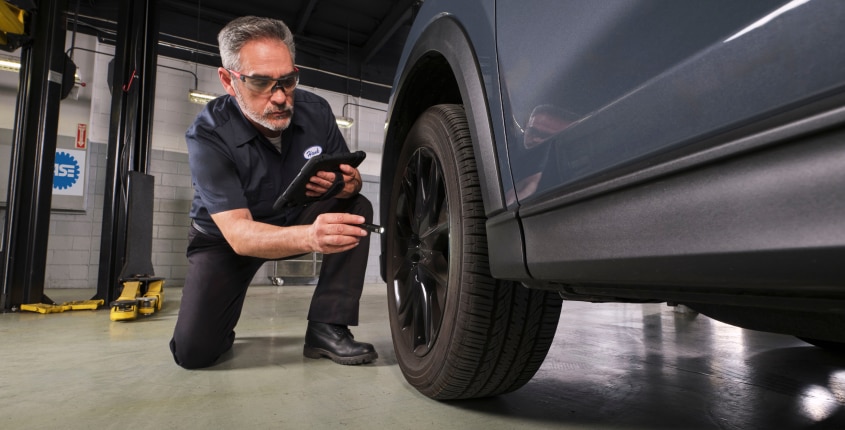 Technician checking tires
